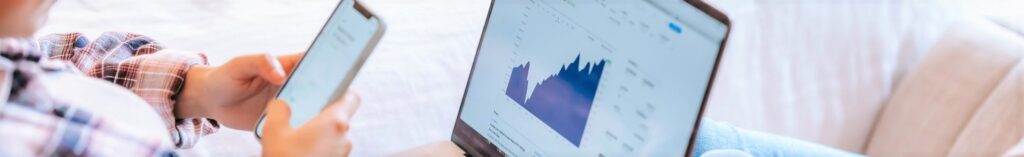 A user on a mobile phone and laptop